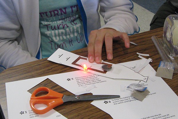 Middle-school girl makes a light-up LED bracelet at Lowell National Historical Park
