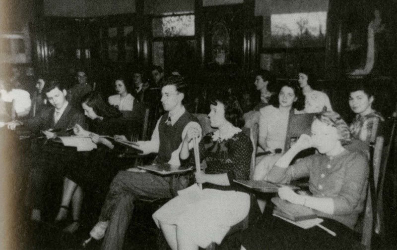 Female and male students in class at the Lowell Teachers College in 1952.