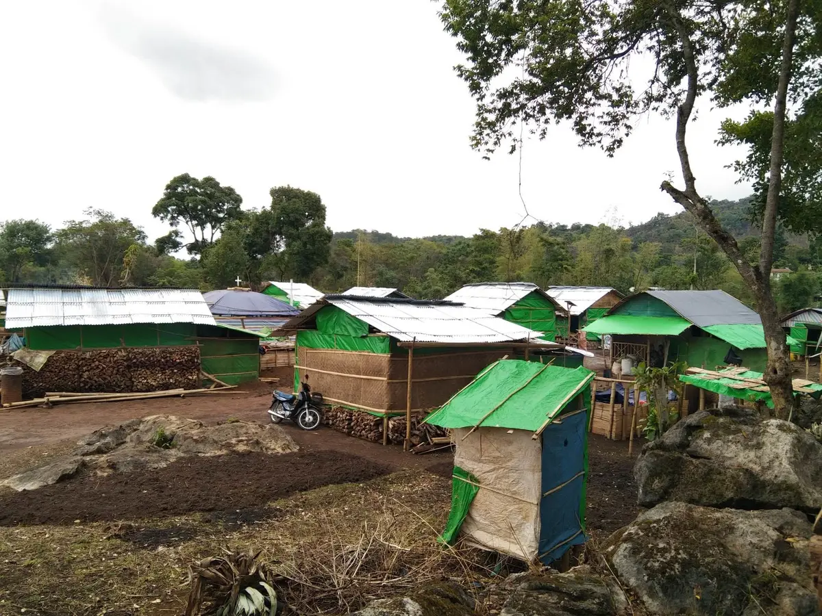 Wood and tarp temporary houses in a camp for internally displaced people in Myanmar