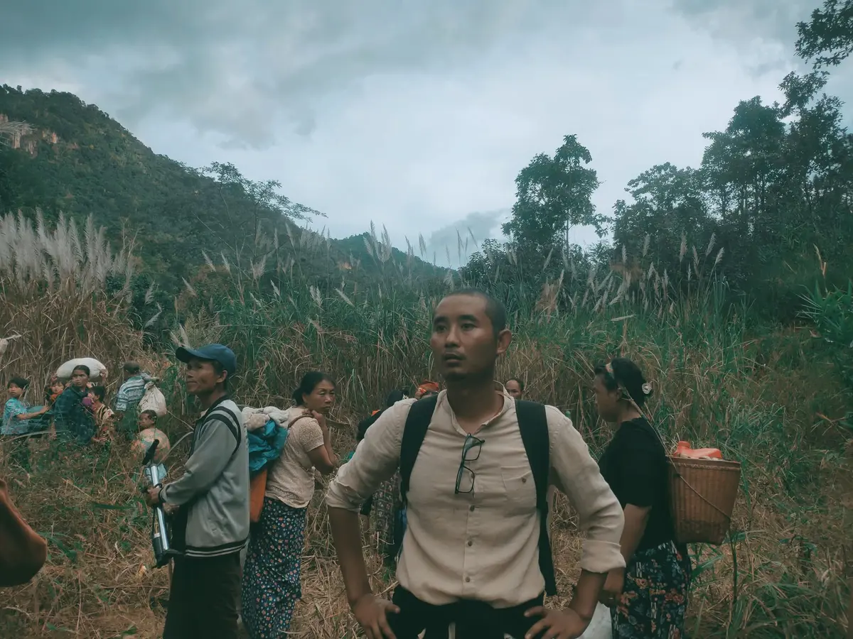 Lugyi No and children fleeing a military attack in a mountainous area of Myanmar