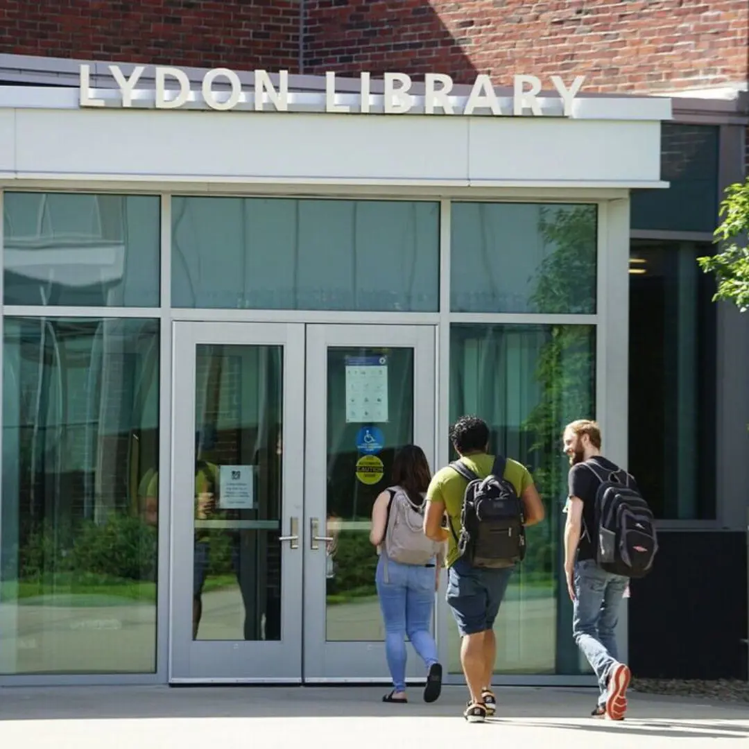 Three students entering Lydon Library.