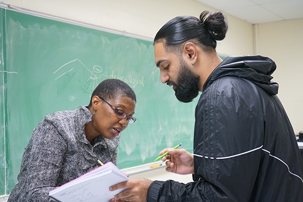 Chemistry Assoc. Teaching Prof. Khalilah Reddie talks to a student after an Organic Chemistry class