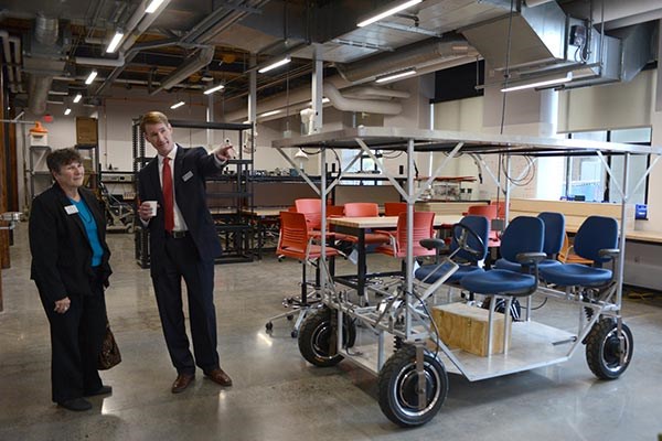 Joseph Hartman, dean of UMass Lowell’s Francis College of Engineering, provides a tour of the college’s new makerspace to Lisa Derby Oden, project manager of the Massachusetts Manufacturing Extension Partnership.
