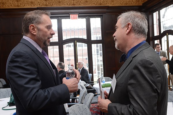 Gary Wallace, executive director of the Lowell Housing Authority, talks with Assoc. Prof. Thomas Pineros-Shields, head of the new M.P.A. program, at the launch event.