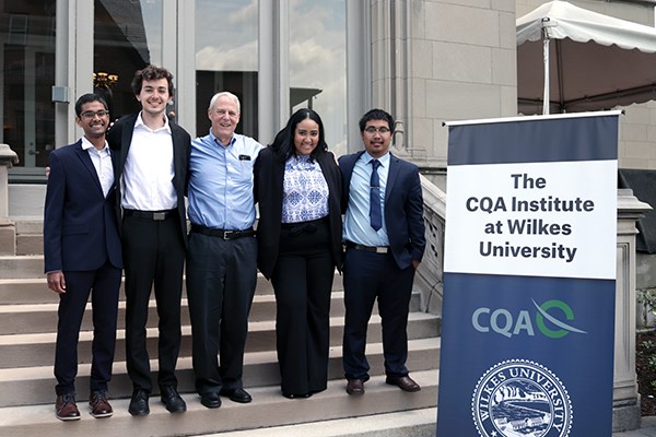 Manning students pose with Ed Keon at the CQA Institute