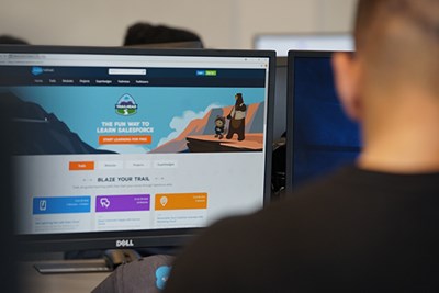 A student uses Trailhead to learn Salesforce in the trading room