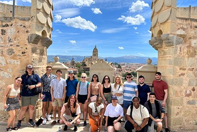 Honors study abroad students in the Exploring Madrid Past and Present class summer 2022 pose at a castle