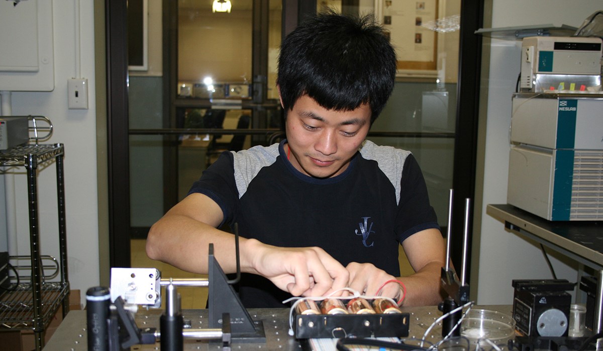 Electrical and Computer Engineering student working with unknown equipment and batteries.