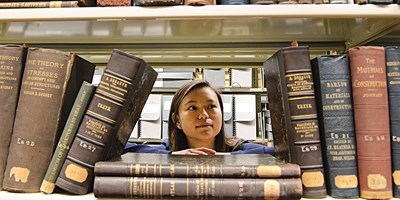 Malinda Reed looks between books at the library