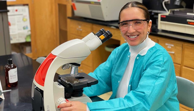 Marita Merheb using a microscope in a UMass Lowell lab