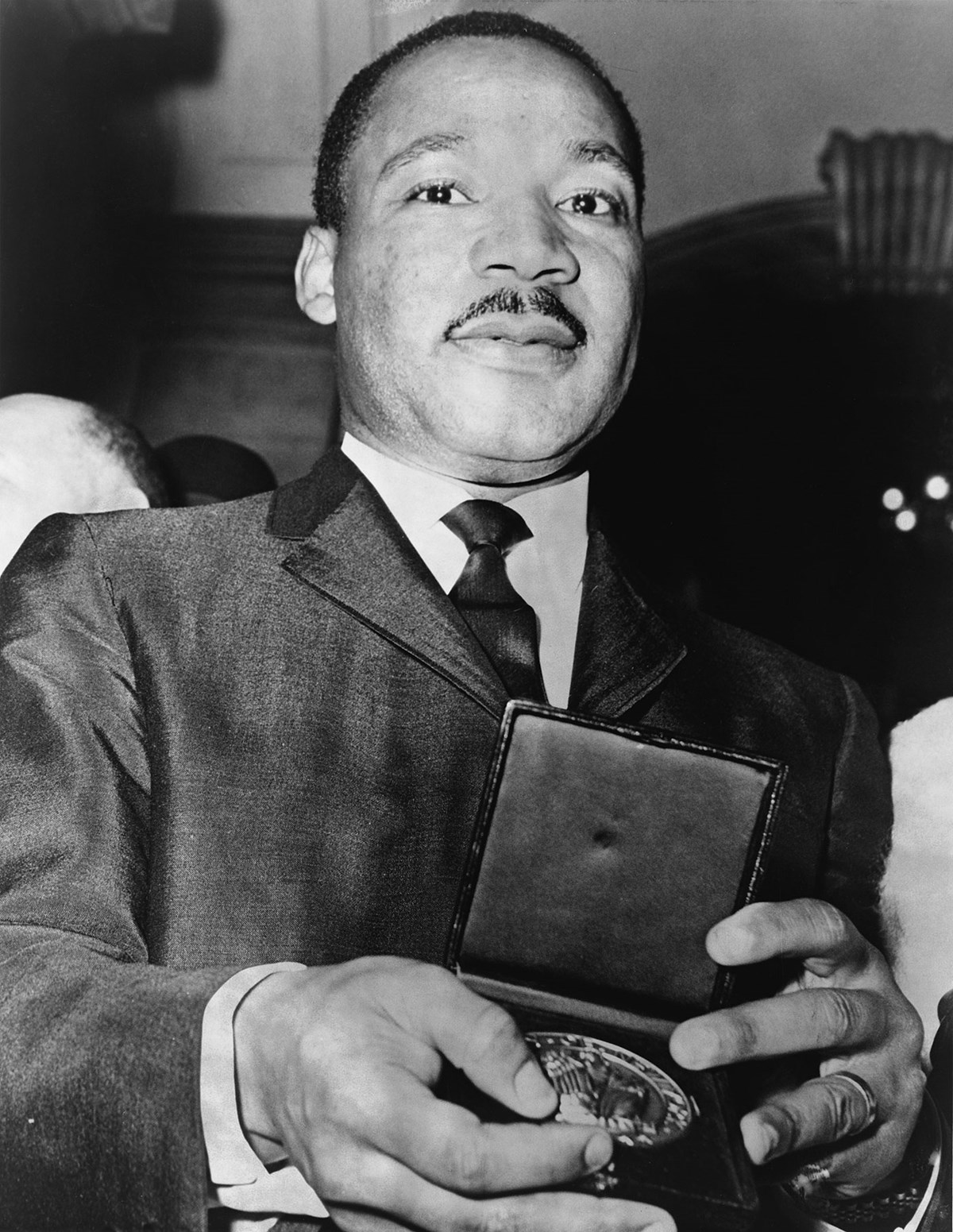 Dr. Martin Luther King, Jr. holding a Nobel Peace prize. In 1964 Martin Luther King, Jr. was awarded the Nobel Peace Prize for his dynamic leadership of the Civil Rights movement and steadfast commitment to achieving racial justice through nonviolent action.
