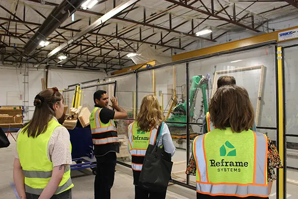 Representatives from MassCEC tour Reframe Systems, an Andover-based startup that builds efficient, resilient homes.