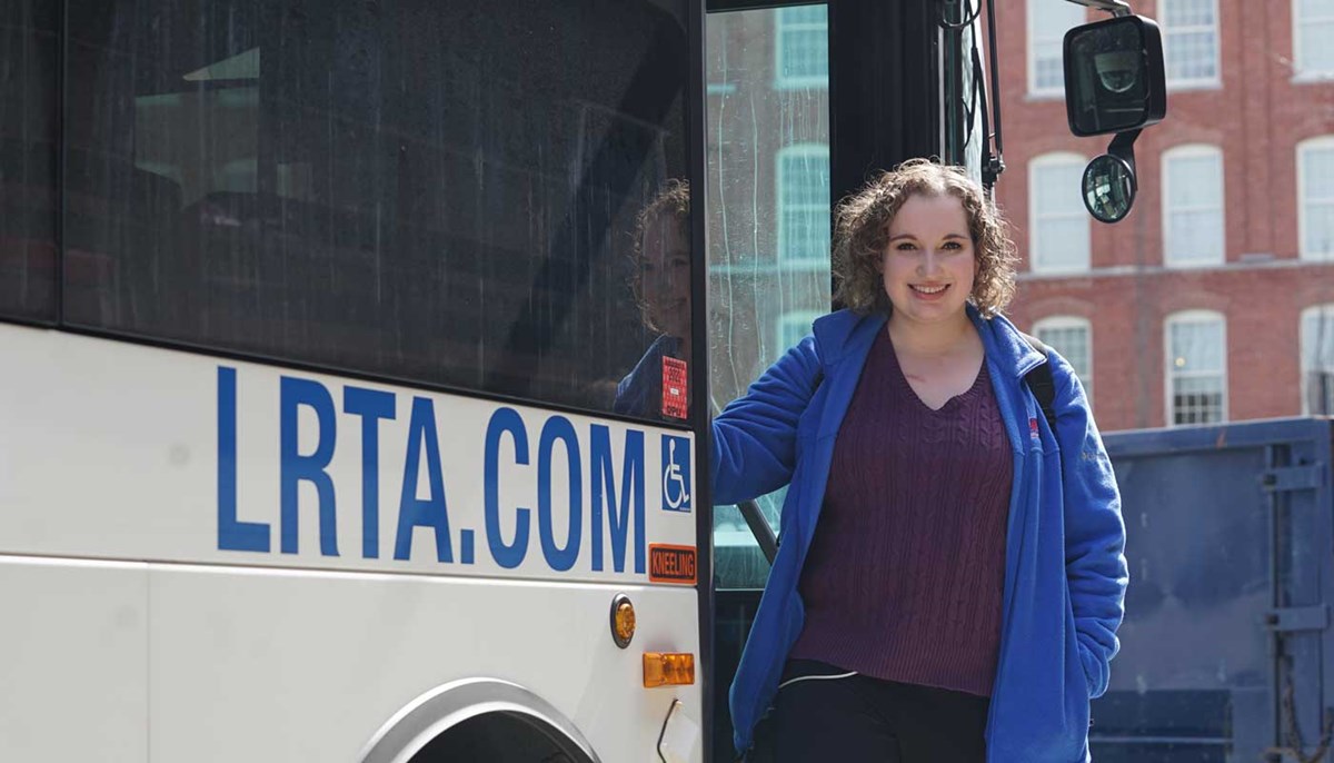   Meaghan OBrien stands next to a bus