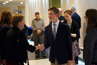 Daniel Russell shakes hands with Senior Vice Chancellor for Finance, Operations and Strategic Planning Joanne Yestramski