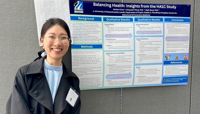 Meilani Chen standing in front of a poster on "Balancing Health: Insights from the HA1C Study."