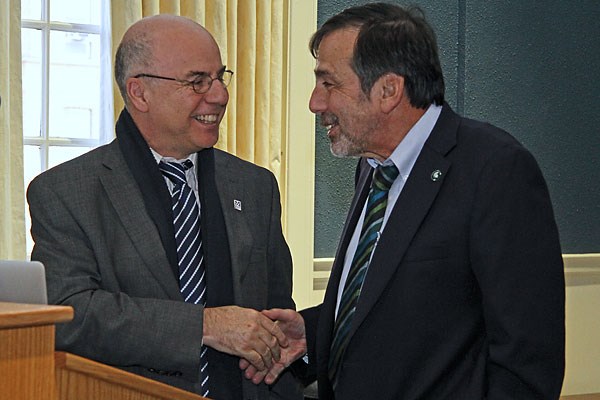 Kennedy College of Sciences Dean Noureddine Melikechi, left, congratulates Michael Liebman, Ph.D., after delivering the inaugural Dean’s Distinguished Guest Lecture on Feb. 1.