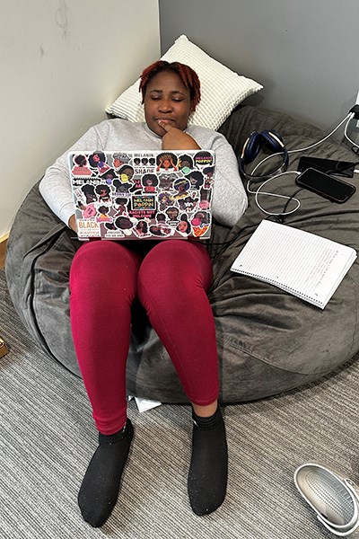 Chi Anuken relaxes on a beanbag chair while studying for a nutrition exam