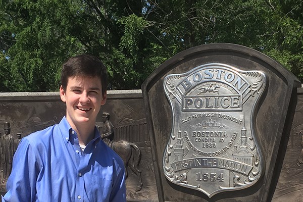 Mike Hanna poses in front of the Boston police department