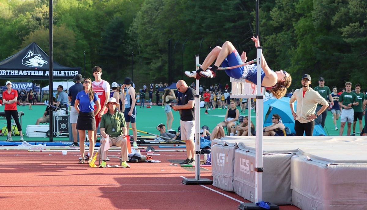 Michael Makiej preforming a high jump.