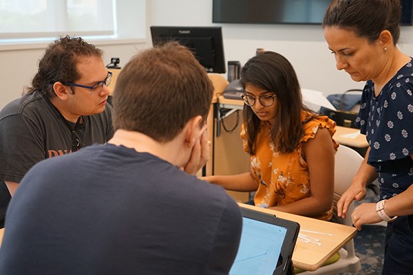 Neslihan Ocali, left, leads a supplemental instruction session for biology students including incoming transfer student James Yakura, left, and Sreya Nalla, a student at George Washington University taking the summer class at UML