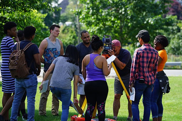 Assoc. Prof. Chronis Stamatiadis teaches Surveying I to a mix of UMass Lowell and Middlesex Community College students every summer. Helene Wambe, far left, is the supplemental instructor.