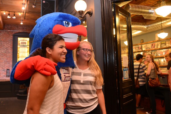 Two students pose with Rowdy the River Hawk at Mill No. 5