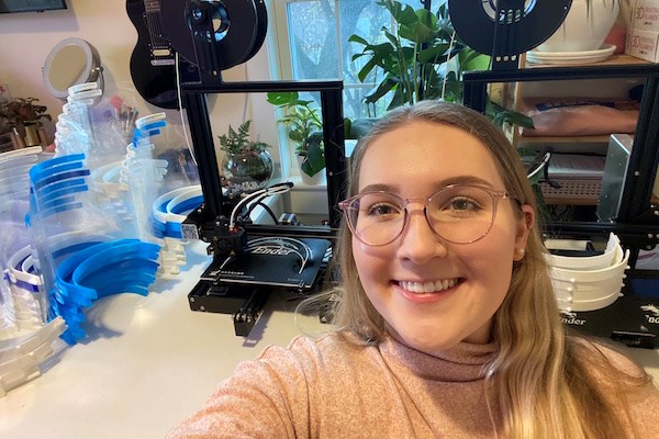 Student Molly Teece with 3D printers in background