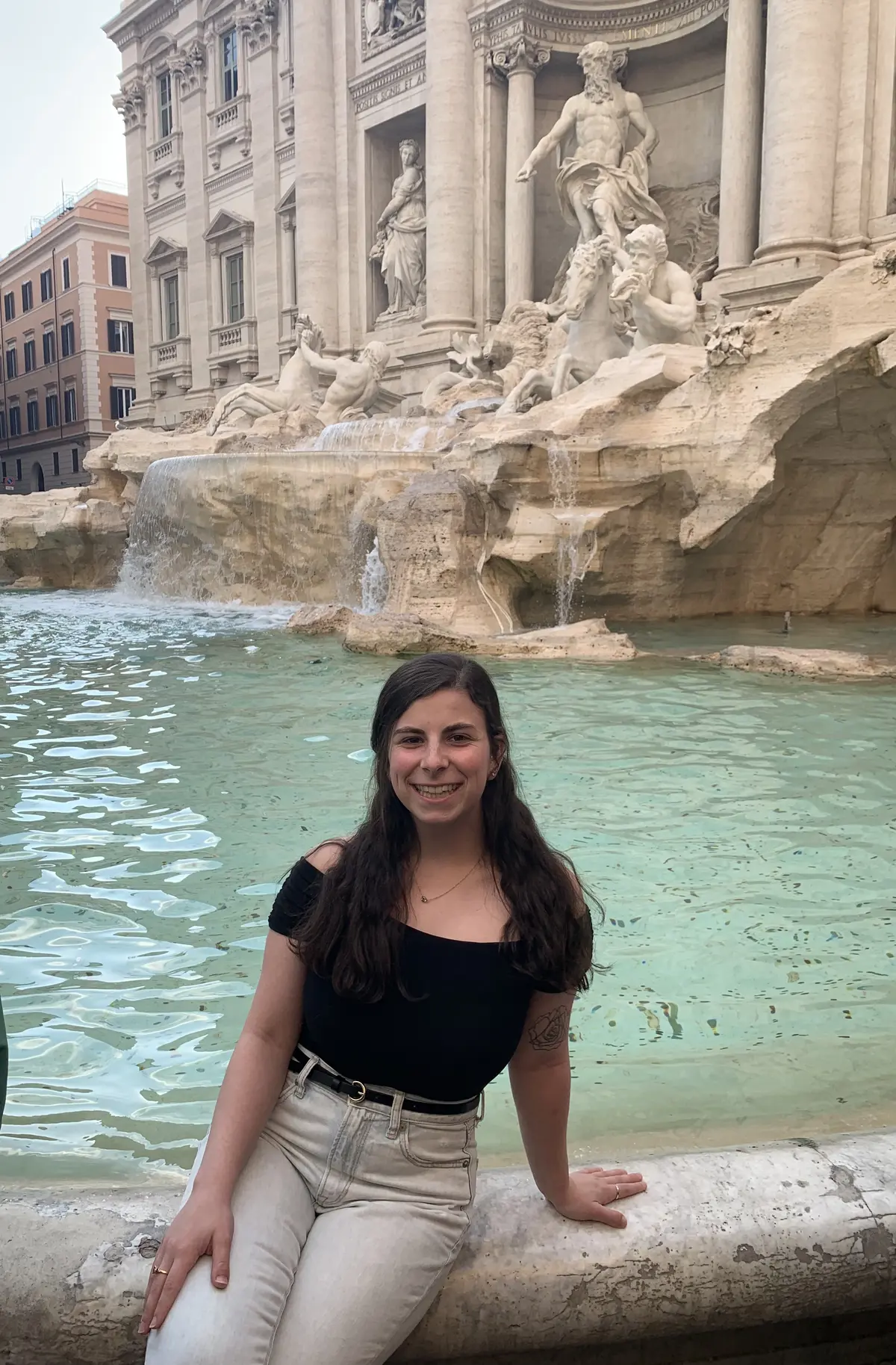 Montana Heise sitting in front of the Trevi Fountain in Rome.