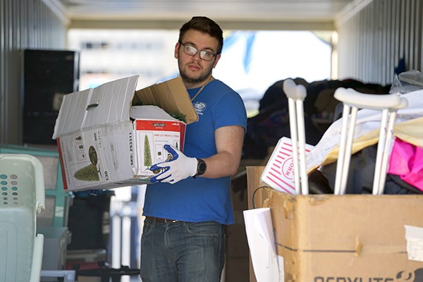 A student volunteer sorts donations on South Campus