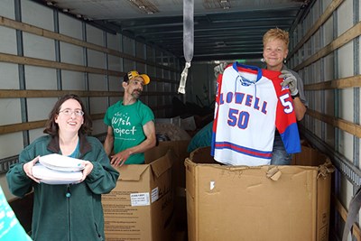 Pamela Beckwith holds up a UML hockey jersey being donated to the Wish Project