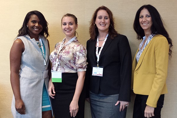 Four Manning School MBA students at the NAWMBA conference