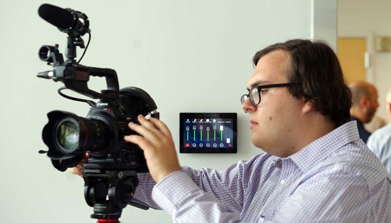 Nick Jarek adjusts a video camera in a digital media studio at UMass Lowell