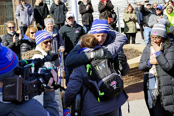 Noelle Lambert hugs family members after the game