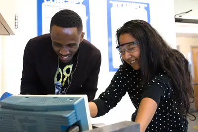 Nuclear Engineering student and faculty looking at a screen.
