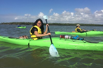 Students paddle their kayaks