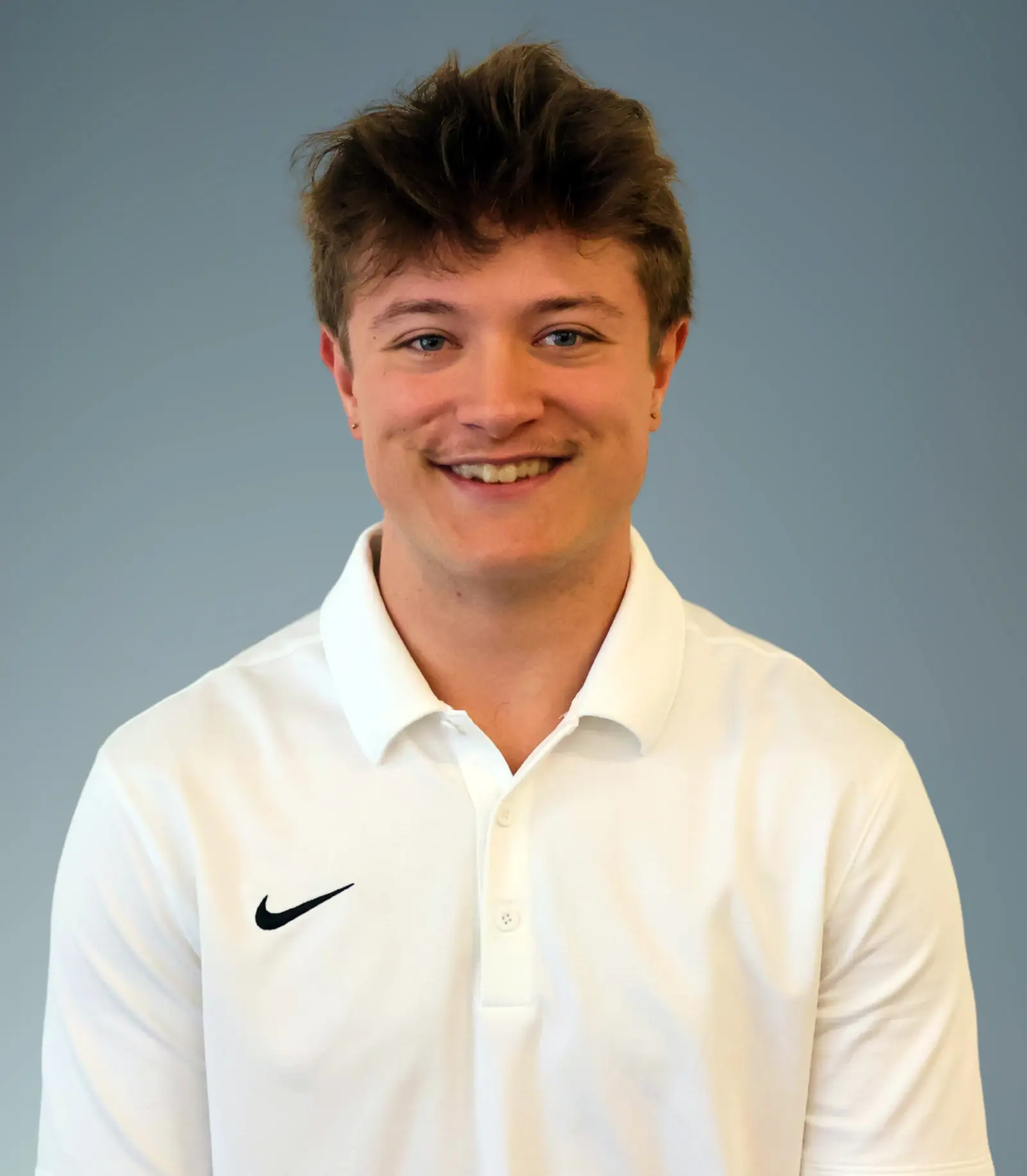 Christian O'Connell wearing a white shirt with a Nike swoosh logo.