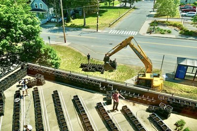 A tractor lifts garden containers onto the O'Leary terrace
