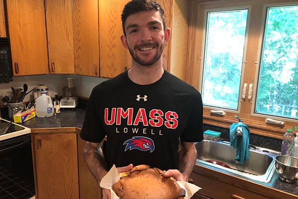 UML honors mechanical engineering major Scott Penfield shows off a Basque cheesecake he cooked for a class assignment