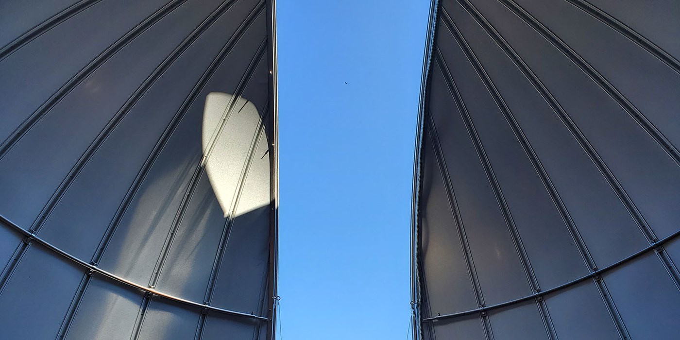The observatory dome is open and the sky is visible. 
