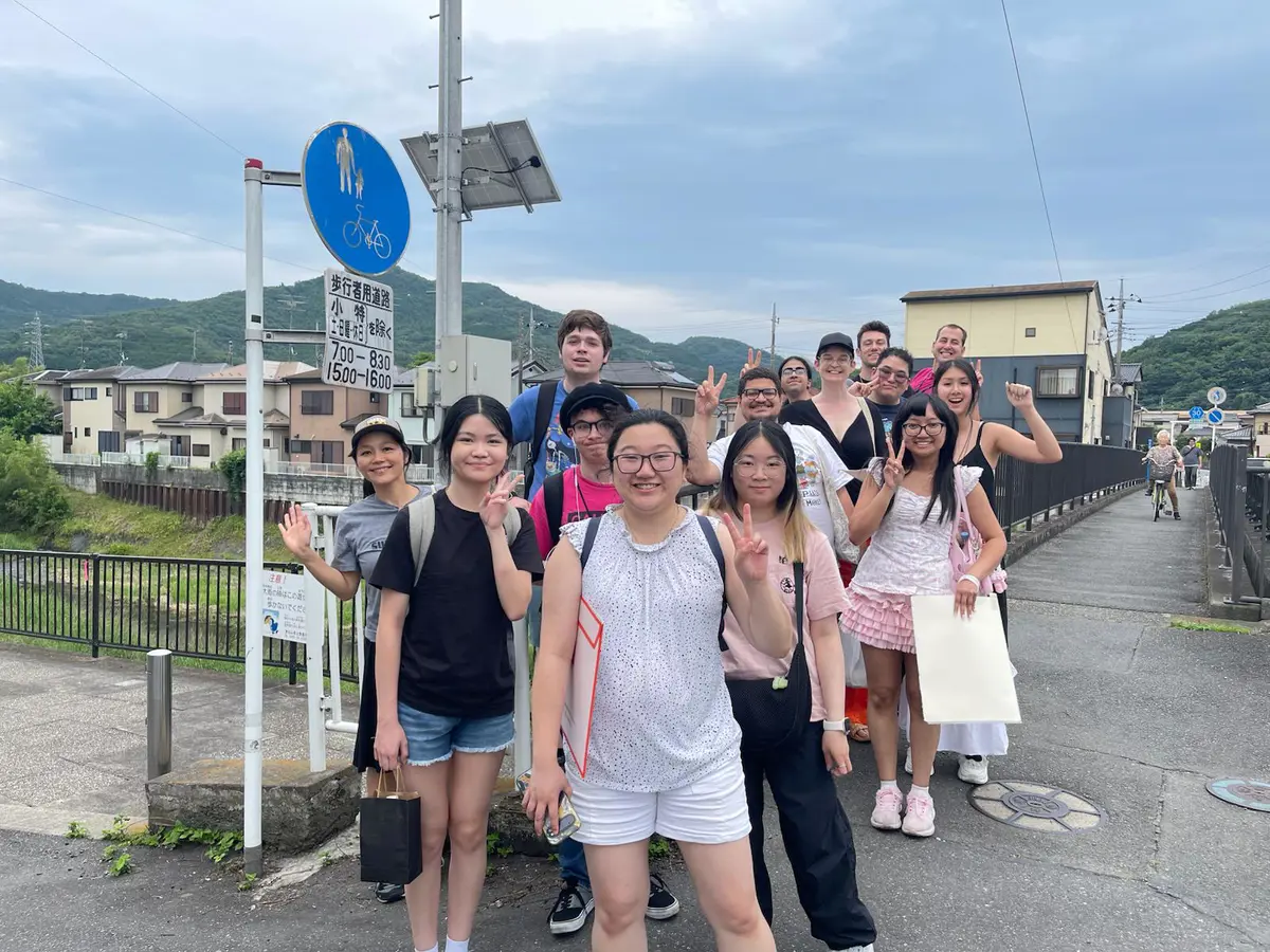 Students and professor standing on a street corner in Ogawa-machi, Japan.