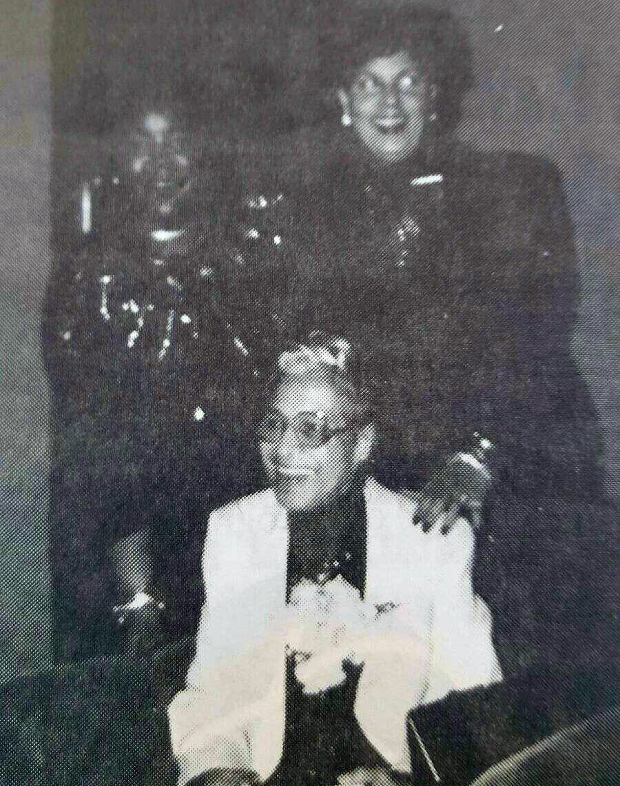 Olga, standing to the right, photographed behind Rosa Parks. 