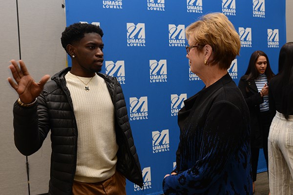 Student Denzel Kumah speaks with Chancellor Jacquie Moloney