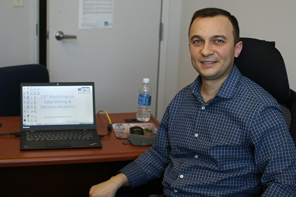 Assist. Prof. Asil Oztekin at desk