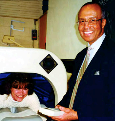 Prof. Joe Dorsey of physical therapy demonstrates an aqua therapy device in the early 1980s