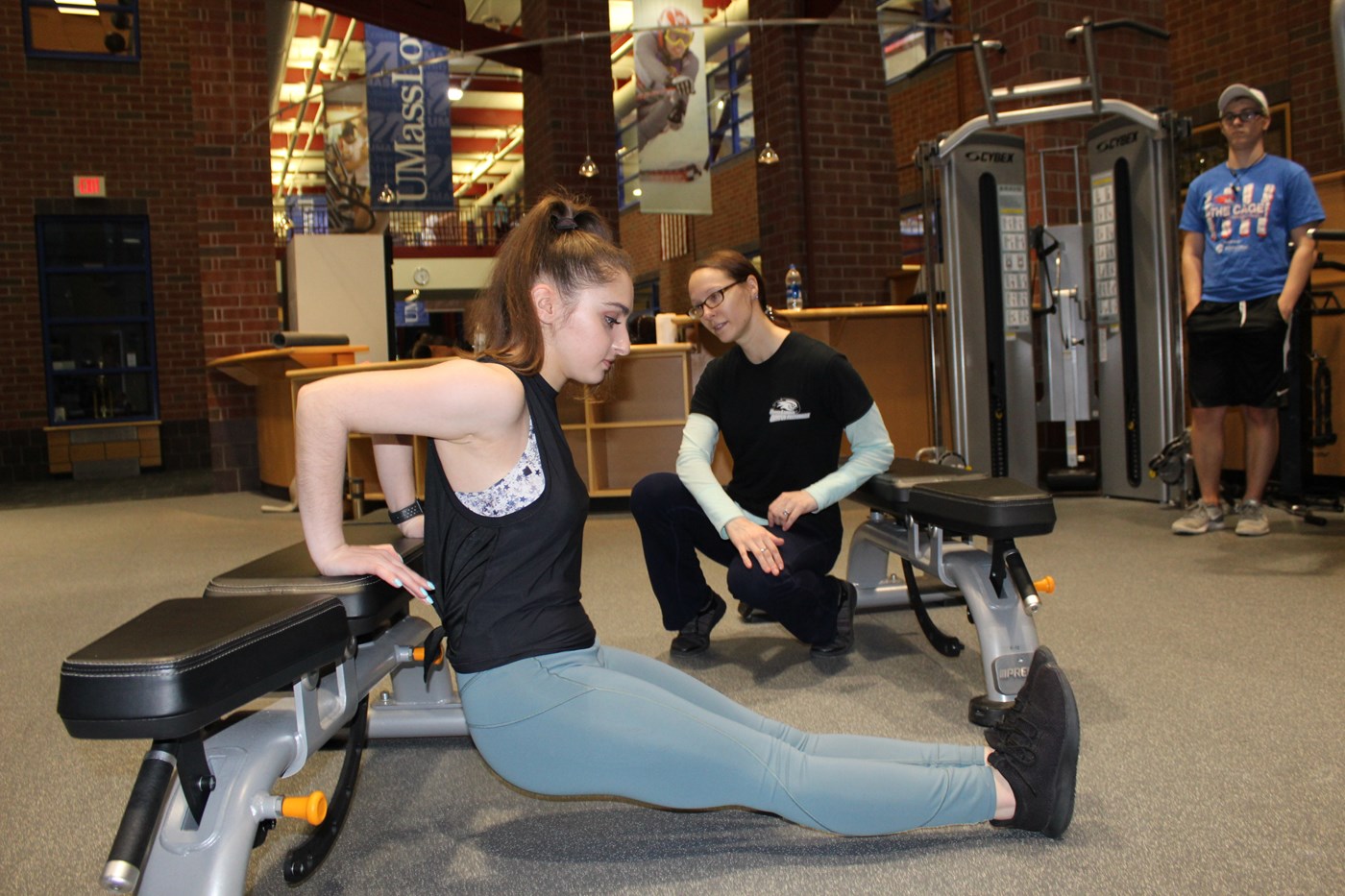 Personal Trainer spotting student client doing a dip on portable bench