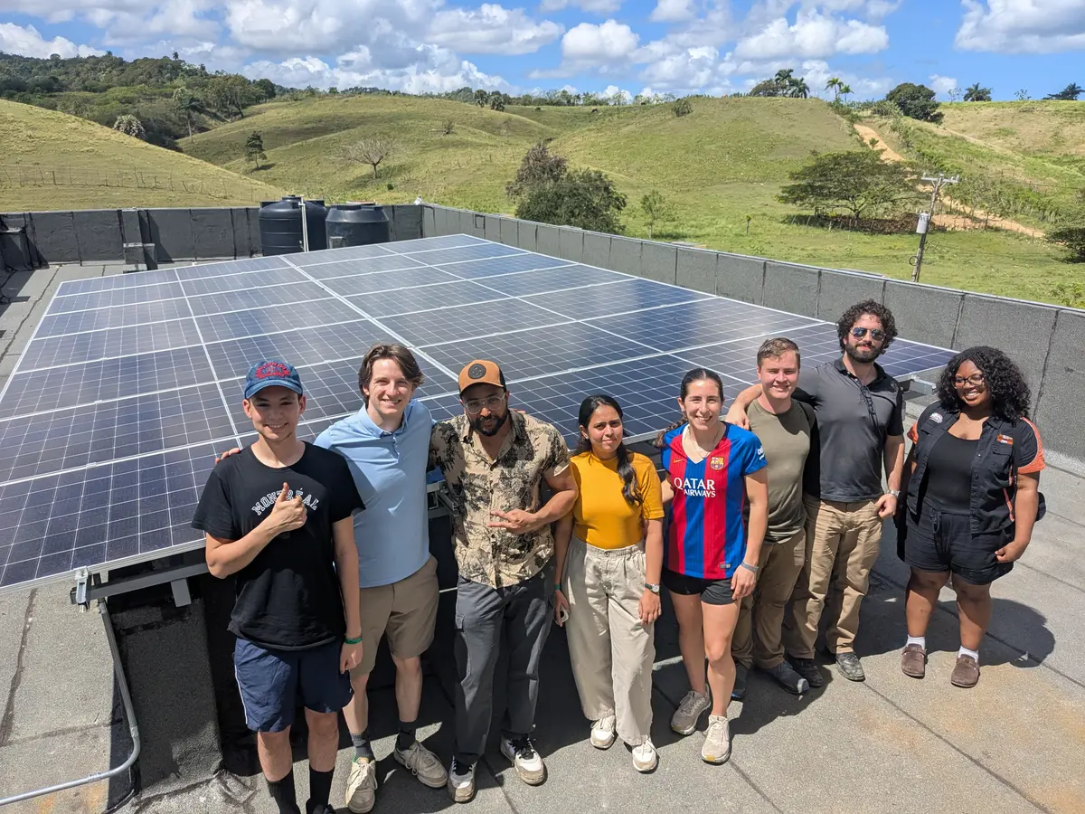 Jacob Hoffman assists with a solar power installation.