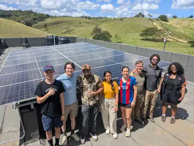 Jacob Hoffman assists with a solar power installation.