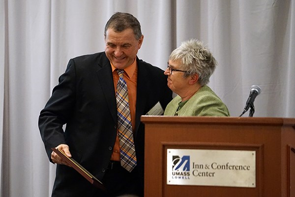 John Doherty receives an alumni award from Anita Greenwood
