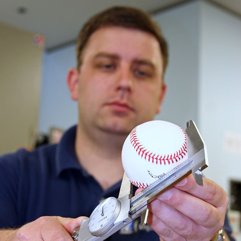 Patrick Drane measures the diameter of a baseball