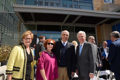 Jacquie Moloney, Janice and Barry Perry, and UMass President Marty Meehan in front of Perry Hall 
